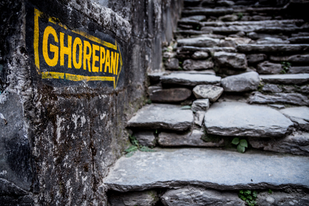 Nepal, March 2017: A sign indicates the way to Ghorepani at Birethanthi, the start of the Annapurna...