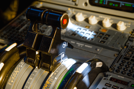 Airbus A320 thrust levers on the centre pedestal instrument panel. Switches and dials visible in the background.の写真素材