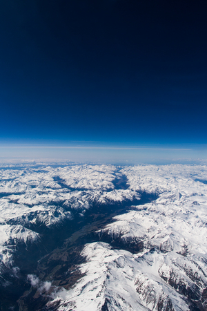 Cloudy skies over europe pictured from high altitude with deep blue skies.の写真素材