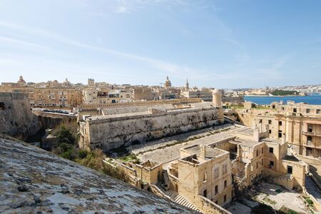 Dilapidated part of Fort St Elmo, Valletta with Valletta in the background on a sunny dayの写真素材