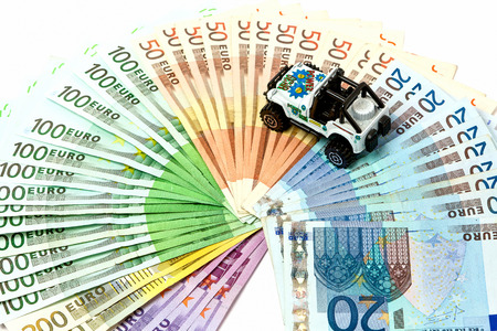 Different euro bills 500 200 100 50 Euro banknotes lying on a table. On top of the money lies a car.の写真素材
