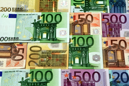 Different euro bills are spread out on a table. The money can be used as travel money lottery win holiday pay or credit to buy a car.の写真素材