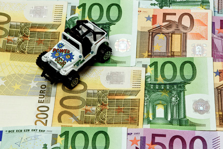 Different euro bills 500 200 100 50 Euro banknotes lying on a table. On top of the money lies a carの写真素材
