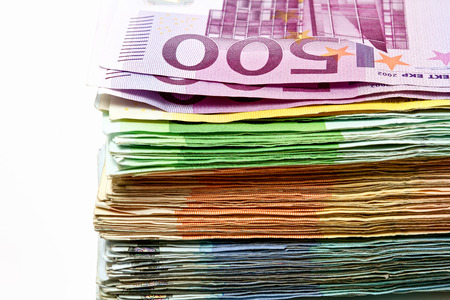 Different euro bills are spread out on a table in the form of a stack of money. の写真素材