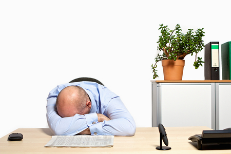 Manager crying at the desk about bad stock prices. The financial crisis has caught up with him.の写真素材