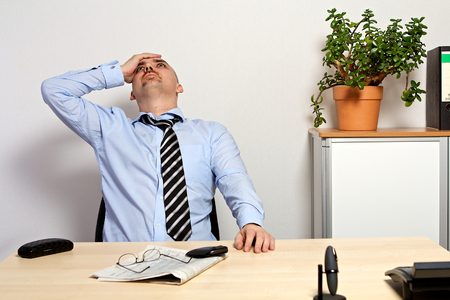 Manager holds his head because of bad share pricesの写真素材