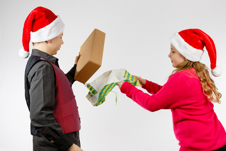 Boy and girl tear a presentの写真素材