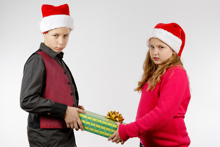 Boy and girl are angry about Christmas presentの写真素材