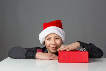 Boy is pleased about a present packed redの写真素材