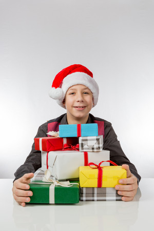 Boy is glad about Christmas presentsの写真素材