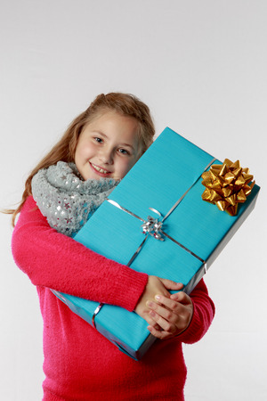 Girl cuddles her present, close-upの写真素材