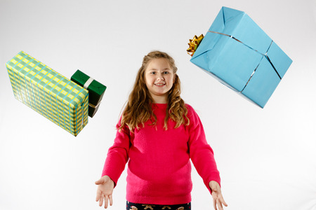 Girl lets presents fell from the skyの写真素材