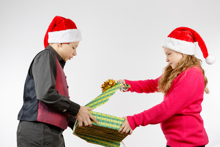 Boy and girl tear a presentの写真素材