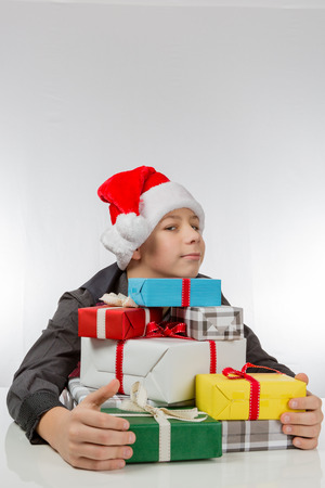 Boy stacks his Christmas presentsの写真素材