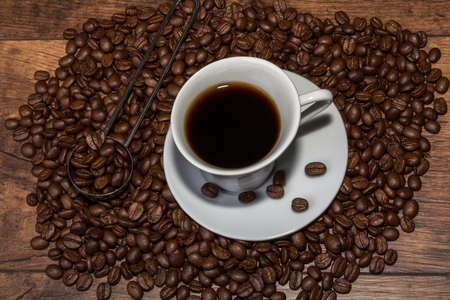 Fresh cup of arabica coffee with aromatic coffee beansの写真素材