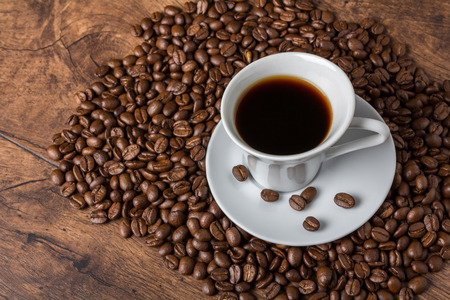 Fresh cup of arabica coffee with aromatic coffee beansの写真素材