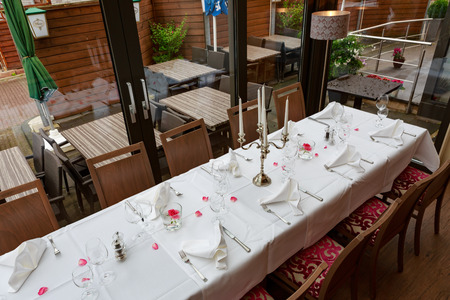 Laid tables reserved for dinersの写真素材