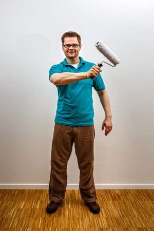 Man paints on imaginary concept wall, vertical formatの写真素材