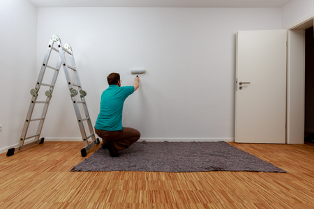 Man painting a wall in whiteの写真素材
