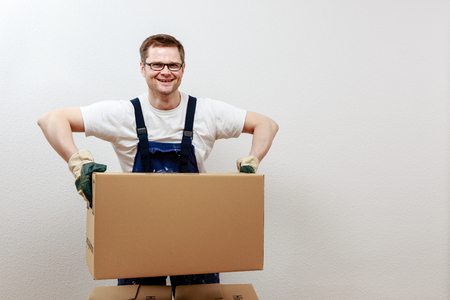 Man lifts heavy boxesの写真素材