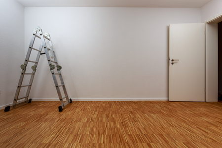 Empty, clean white room with aluminum ladderの写真素材
