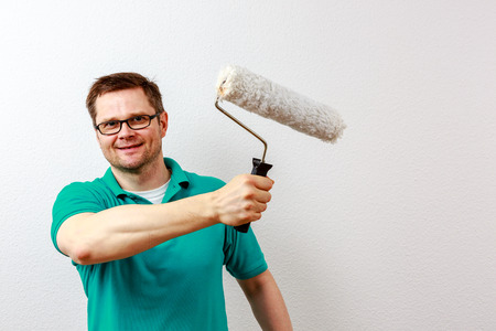 Man paints on imaginary concept wallの写真素材