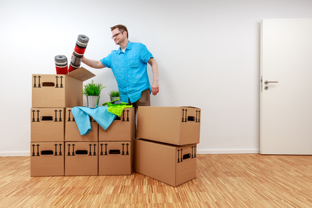 Man empties moving boxesの写真素材