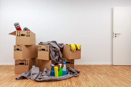 Renovated room with filled moving cartons and cleaning agentsの写真素材