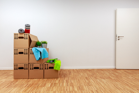 Moving cartons in empty white room with wooden parquetの写真素材