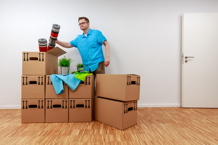 Man empties moving boxesの写真素材