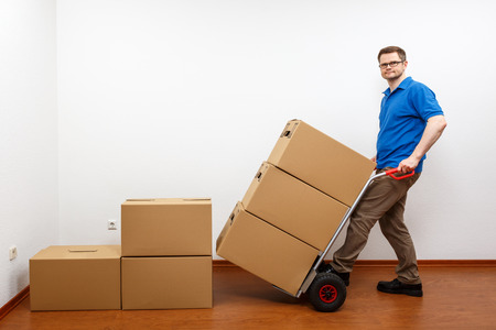 Man stacking boxes on top of each otherの写真素材