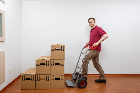 Man pushes a sack barrowの写真素材