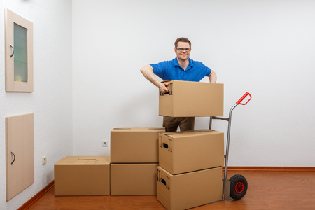 Man stacking boxes on top of each otherの写真素材