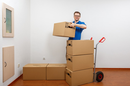 Man stacking boxes on top of each otherの写真素材