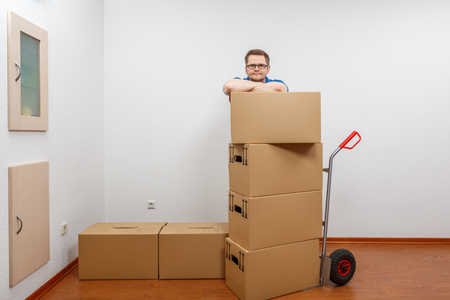 Man stacking boxes on top of each otherの写真素材
