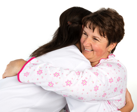 A senior woman and nurse huggingの写真素材