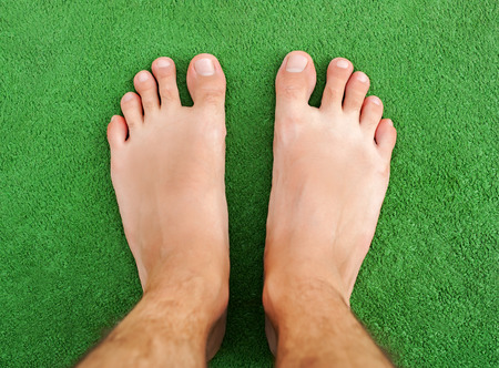 Foot on green grass