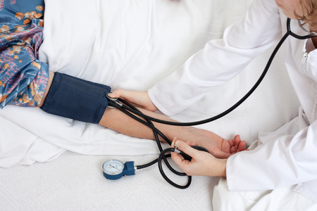 Taking blood pressure in the hospitalの写真素材
