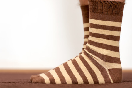 Wearing comfortable striped socks at home.の写真素材