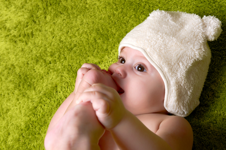 Joyful baby boy on green backgroundの写真素材