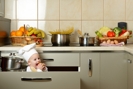 Adorable baby boy in kitchenの写真素材