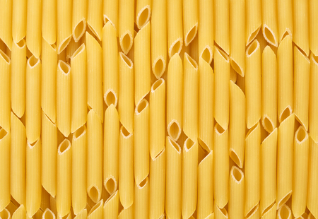 Italian uncooked pasta penne sorted vertically for background or texture.の写真素材