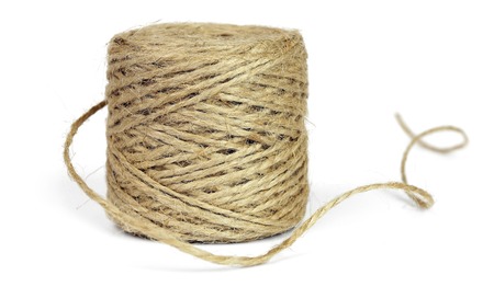 Skein of jute rope for packing, isolated on a white background.の写真素材