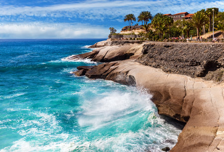 Costa Adeje, Tenerife, Spain - February 7, 2019: View of the rocky cost and the famous Casa del Duque on a cliff in the Playa del Duque area in popular resort in southern coast of Canary Islands.のeditorial素材
