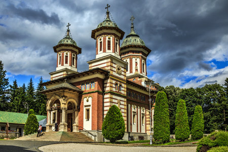 Sinaia, Prahova County, Romania - July 1, 2018: The main cathedral temple Katholikon in the Orthodox Sinaia Monastery in Prahova Valley, against the stormy sky.のeditorial素材