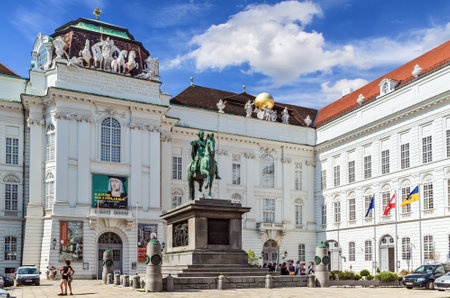 Vienna, Austria - August 27, 2019: The bronze statue of Emperor Kaiser Joseph II in the Josefplatz and the National Library of the royal Hofburg Palace complex.のeditorial素材