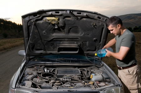 Adult man filling windshield washer reservoirの写真素材