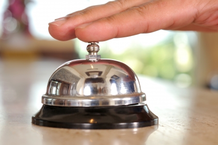 Hand of a man using a hotel bell - a series of HOTEL images