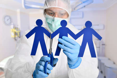 Scientist cutting paper with scissors to emphasize the importance social distancing concept.