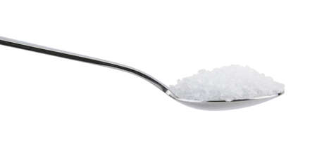 Spoon full of salt isolated on white backgroundの写真素材